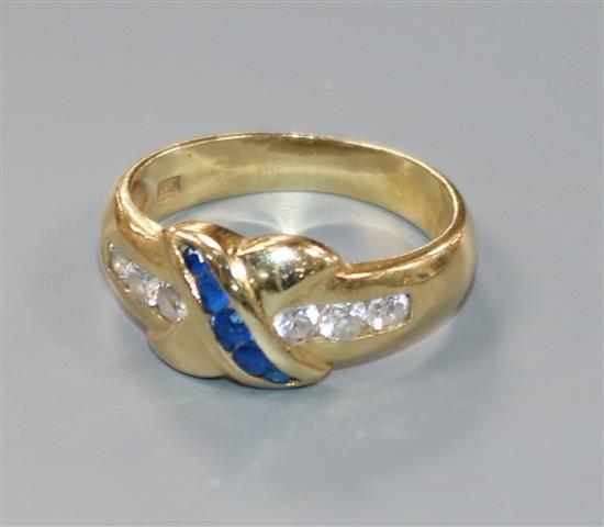 A modern 585 yellow metal and two colour sapphire? ring with X motif, size O.
